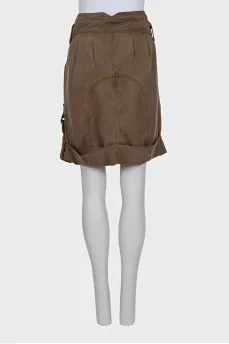 Denim skirt decorated with buckles