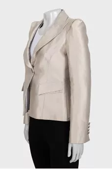 A cropped fitted jacket with a button
