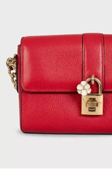 Red leather bag with an accent lock