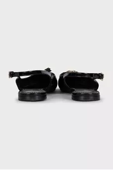 Black patent leather slingbacks with decor