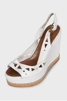 Leather sandals decorated with perforations