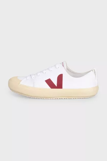White lace-up sneakers with a red logo