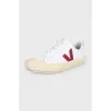 White lace-up sneakers with a red logo