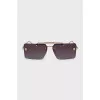 Sunglasses with a gold frame and a rectangular lens