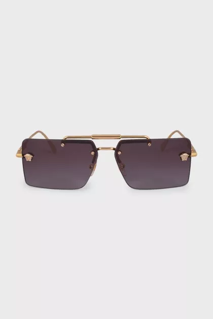 Sunglasses with a gold frame and a rectangular lens