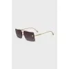 Sunglasses with a gold frame and a rectangular lens