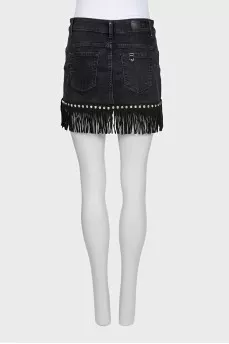 Black denim mini skirt decorated with fringe