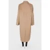 A woolen long coat with a tag