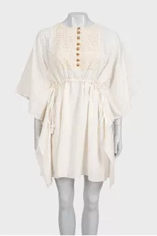 White dress with branded print and tag