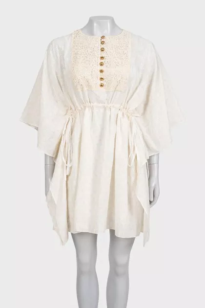 White dress with branded print and tag
