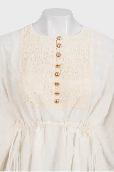 White dress with branded print and tag