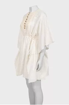 White dress with branded print and tag