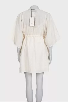White dress with branded print and tag