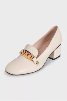 White leather shoes with gold decor