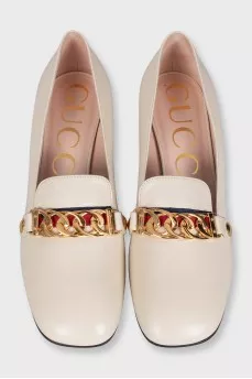 White leather shoes with gold decor