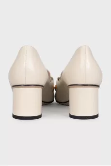 White leather shoes with gold decor