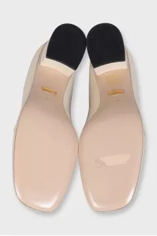 White leather shoes with gold decor