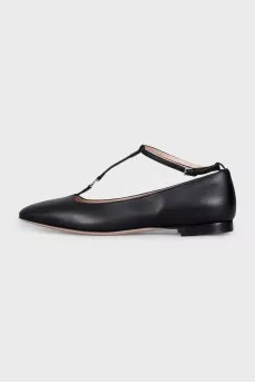 Black leather ballet flats with a tag strap