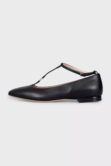 Black leather ballet flats with a tag strap