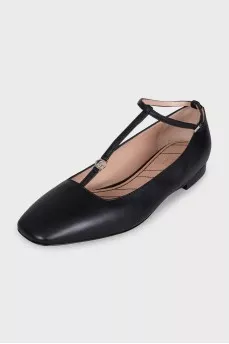 Black leather ballet flats with a tag strap