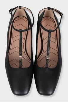 Black leather ballet flats with a tag strap