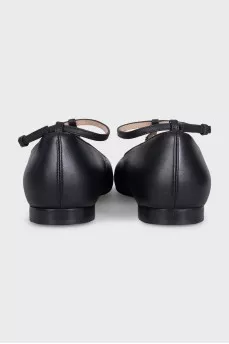 Black leather ballet flats with a tag strap