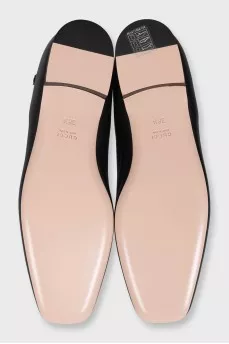 Black leather ballet flats with a tag strap