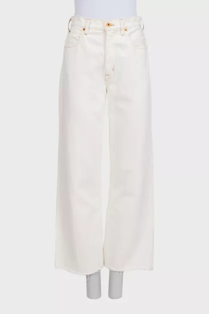 White wide-leg jeans with raw hems