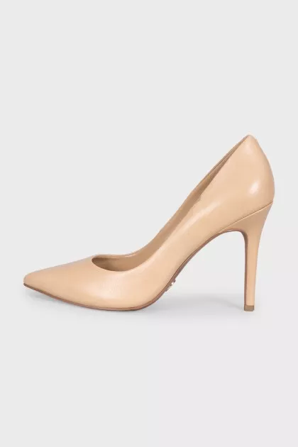 Beige pumps with a gold logo