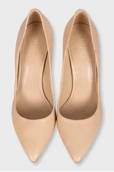Beige pumps with a gold logo