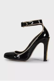 Black leather shoes with gold trim