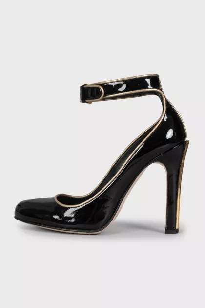 Black leather shoes with gold trim