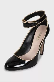Black leather shoes with gold trim