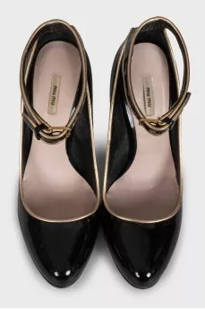 Black leather shoes with gold trim