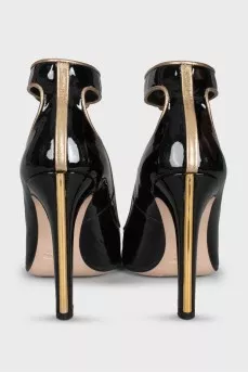 Black leather shoes with gold trim