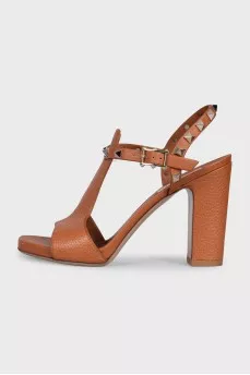 Brown leather heeled sandals decorated with studs