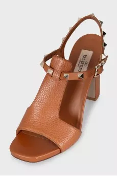 Brown leather heeled sandals decorated with studs