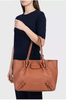Brown leather tote bag with tag