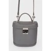 Grey leather bag with silver clasp, red leather inside