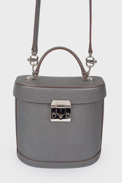Grey leather bag with silver clasp, red leather inside