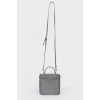 Grey leather bag with silver clasp, red leather inside