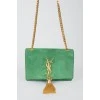 Green sued handbag with golden fittings, on the button