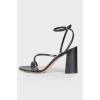 Solid heeled sandals with a tag