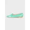 Green loafers with studs and tag
