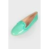 Green loafers with studs and tag