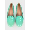 Green loafers with studs and tag