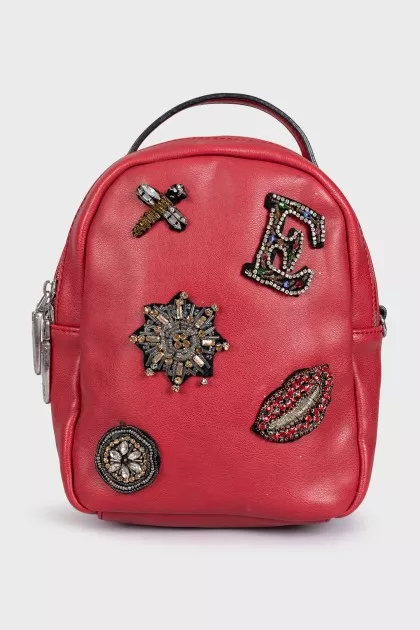 Red leather backpack with decor