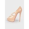 Varnished leather shoes on a high stilettos with a tag
