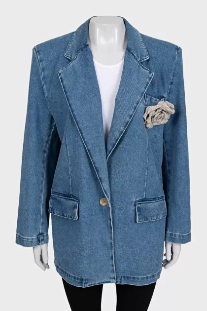 Blue denim jacket with a brooch