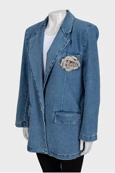 Blue denim jacket with a brooch